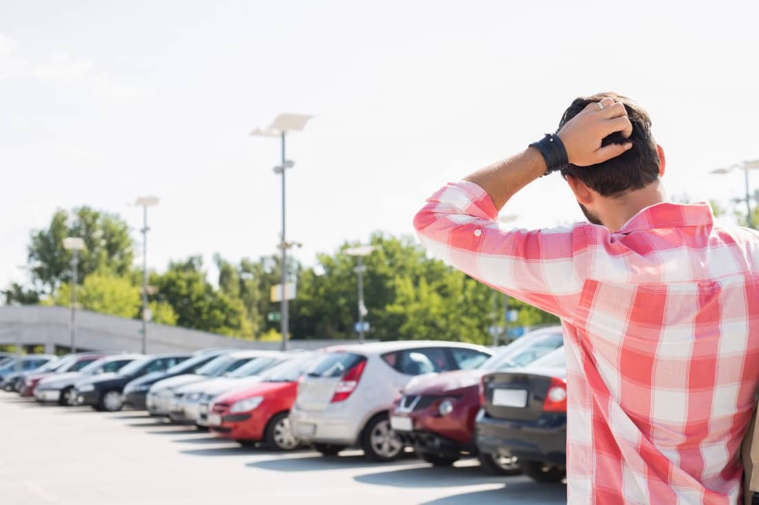 young man wondering about new car, man thinking